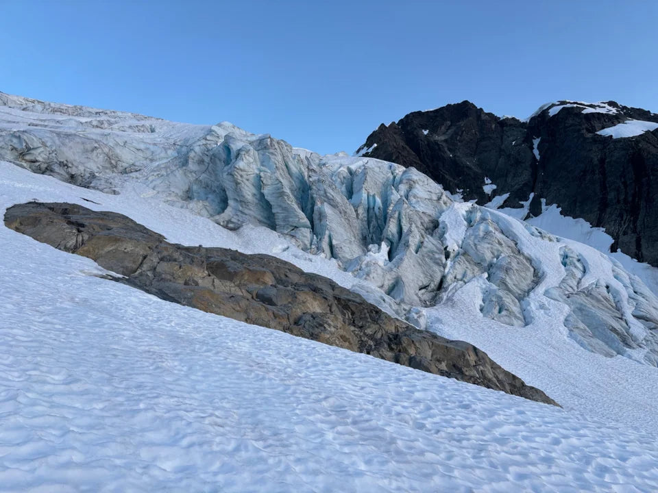 Tall blue-white ice columns below the dark rock of Mt. Pelion.