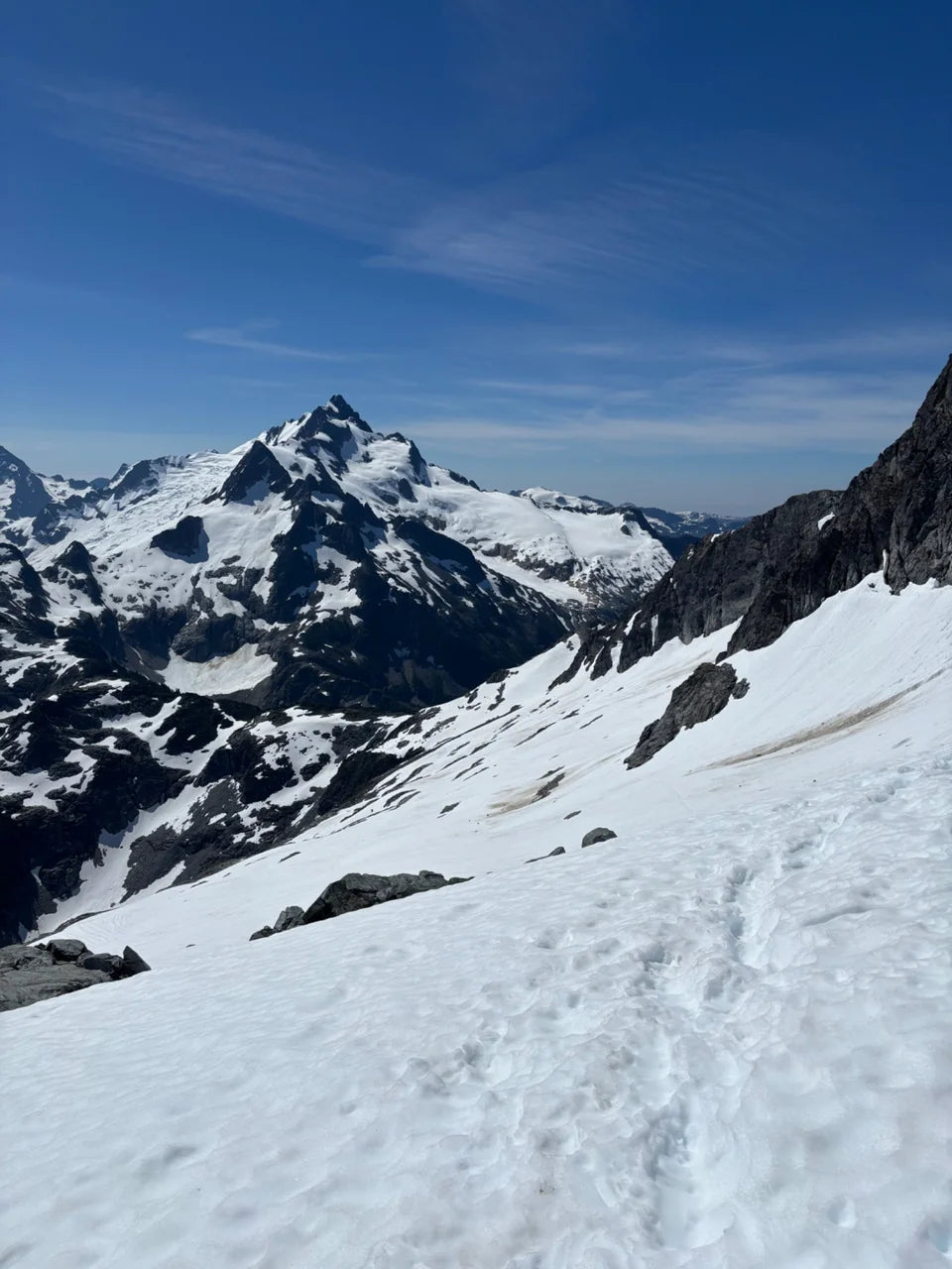 Snow-covered Mt. Tantalus beyond a sloping glacier.