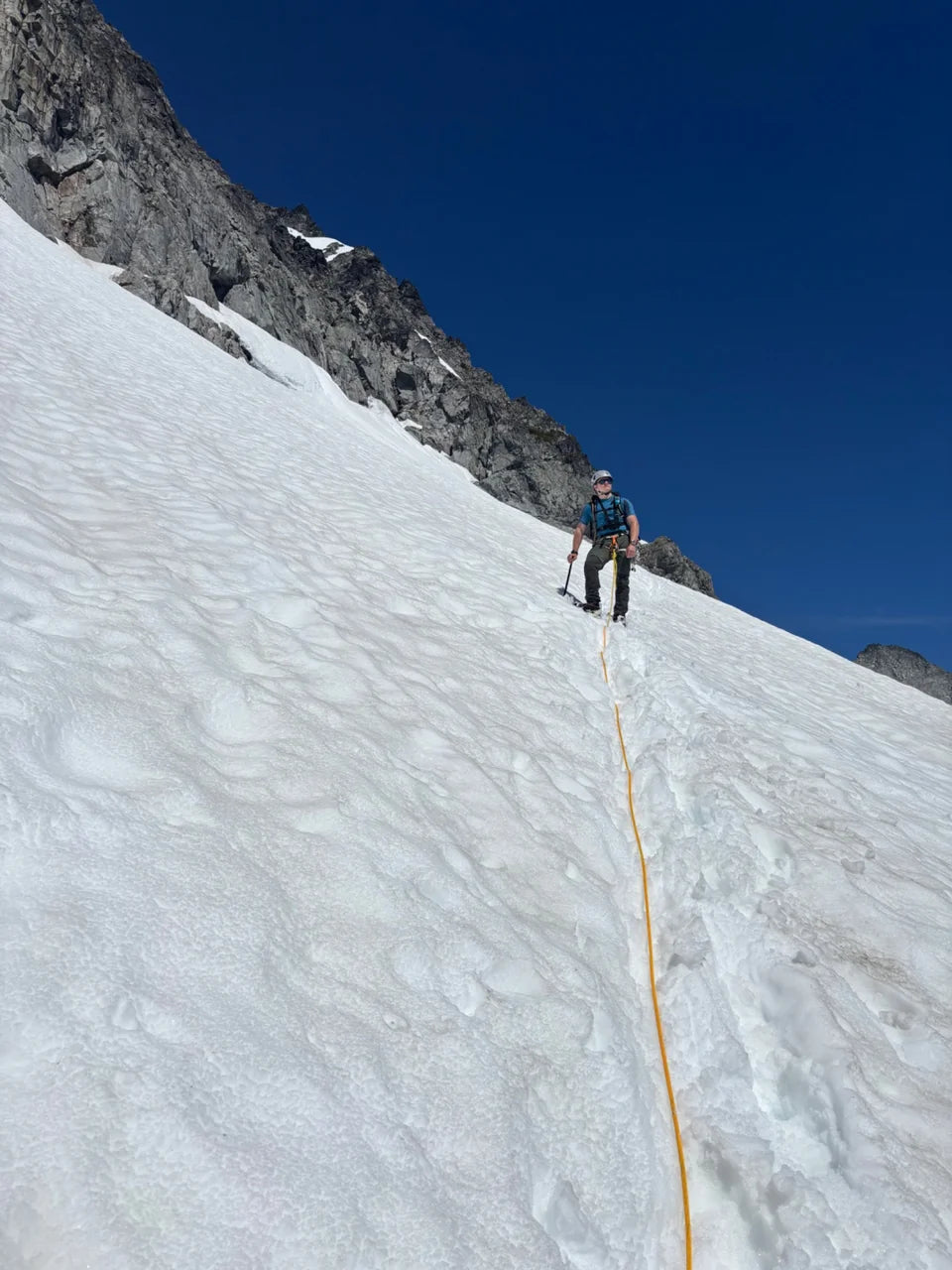 Oscar on a steep snow slope beneath the rock face of Mt. Pelion.